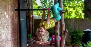 Hanging upside down outside on a climbing bar